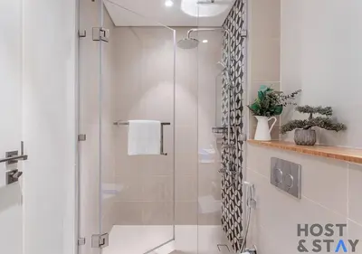 a shower with a glass door in a bathroom at Elegant 2-BR Retreat In Dubai Hills in Dubai