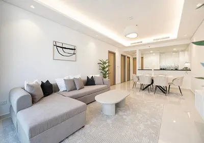 a living room with a couch and a table at Bright High Floor Apartment in a 5 Star Hotel Resident Tower w Burj View and access to 64th Infinity Pool, Gym, Sauna, Spa, Restaurants, Bars and more in Dubai