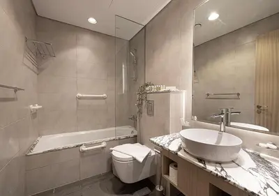 a bathroom with a sink and a tub and a toilet at Bright High Floor Apartment in a 5 Star Hotel Resident Tower w Burj View and access to 64th Infinity Pool, Gym, Sauna, Spa, Restaurants, Bars and more in Dubai