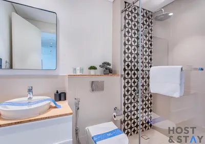 a bathroom with a sink and a shower at Chic Urban 2BR at Collective 2 in Dubai