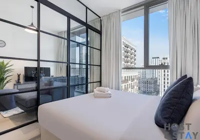 a bedroom with a white bed and a large window at Modern 1bed Haven in Dubai Hills in Dubai