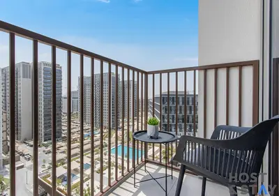 a balcony with a table and a bench on a balcony at Minimalist 2BR in Dubai Hills in Dubai