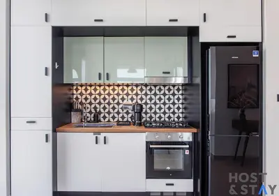 a kitchen with white cabinets and a stove at Amazing 2BR in Collective 2 in Dubai