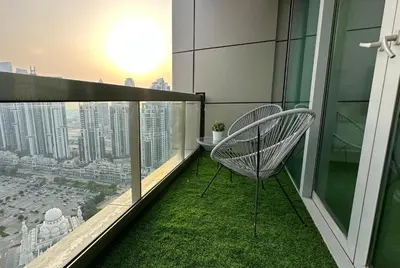 a balcony with two chairs and a view of a city at Luxury Family Studio Close to Dubai Mall and Burj Khalifa in Dubai