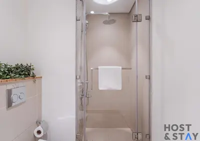 a shower with a glass door in a bathroom at Serene 1BR Getaway In Collective in Dubai
