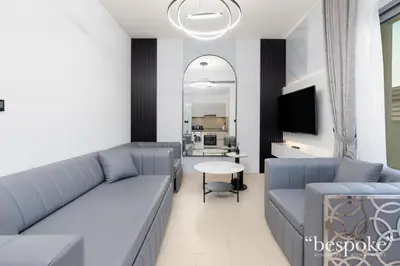 a living room with a couch and a table at Bespoke Holiday Homes - Sobha Creek Vistas Reserve in Dubai
