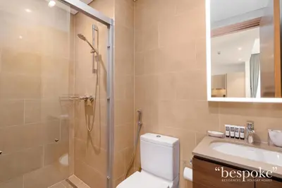 a bathroom with a shower and a toilet and a sink at Bespoke Holiday Homes - Sobha Creek Vistas Reserve in Dubai