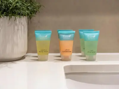 a group of four bottles of sunscreen sitting on a counter at The Burj Khalifa Suite Luxury 2-bed in Burj Royale in Dubai