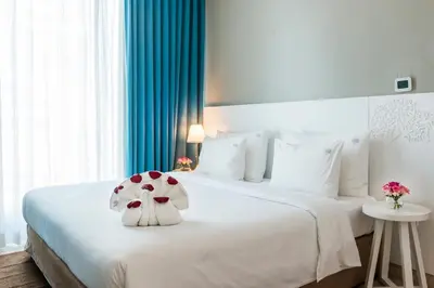 a bedroom with a white bed with a stuffed animal on it at Jannah Place Dubai Marina in Dubai