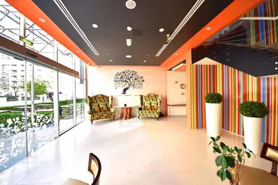 a lobby with chairs and a table in a building at Jannah Place Dubai Marina in Dubai