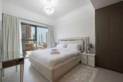 a bedroom with a large bed and a large window at 2 BR Dubai Luxury apartment Full Burj Views in Dubai
