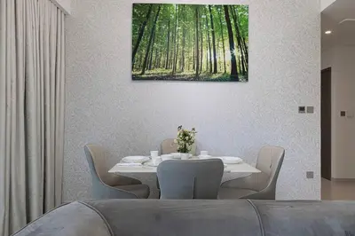 a dining room with a white table and chairs at 2 BR Dubai Luxury apartment Full Burj Views in Dubai