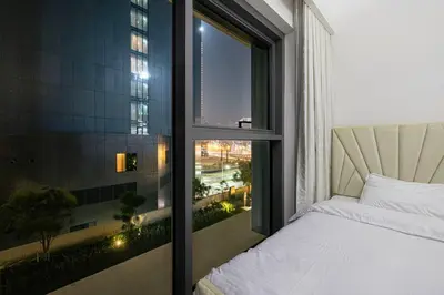 a bedroom with a bed and a window with a view at 2 BR Dubai Luxury apartment Full Burj Views in Dubai