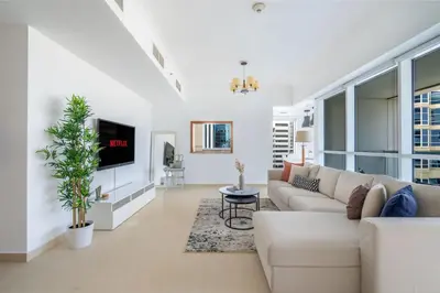 a living room with a couch and a tv at GuestReady - Home away from home in JLT in Dubai