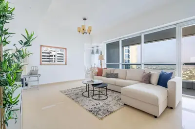 a living room with a white couch and a table at GuestReady - Home away from home in JLT in Dubai
