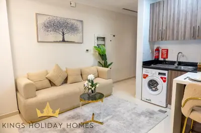 a living room with a couch and a washing machine at Dunya tower 2 downtown burj khalifa street Kings in Dubai