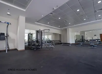 a gym with a large room with treadmills and machines at Dunya tower 2 downtown burj khalifa street Kings in Dubai