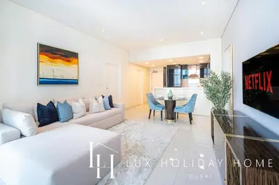 a living room with a couch and a table at LUX The Bays Edge Canal View Suite in Dubai