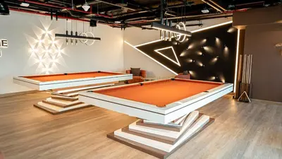 two snooker tables in a room with at Medore Brand New 1 and a half Bedroom apartment in Dubai