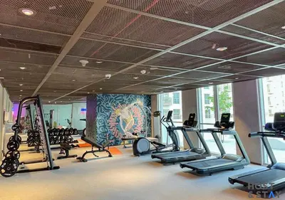 a gym with several treadmills and cardio machines at Lux 1BR Near Dubai Hills Mall in Dubai