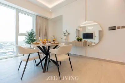a dining room with a table and chairs and a mirror at Me Do Re - Luxury Living 1 BR with Panoramic View - Zed Living in Dubai