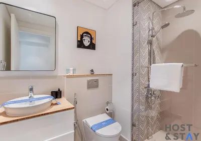 a bathroom with a toilet and a sink and a mirror at Stunning 1bed In Dubai Hills in Dubai