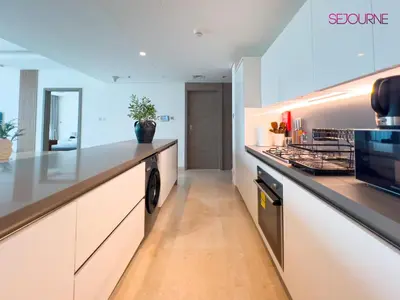 a kitchen with white cabinets and a counter top at #140 Elegant 1BR with Burj Khalifa View in Business Bay in Dubai