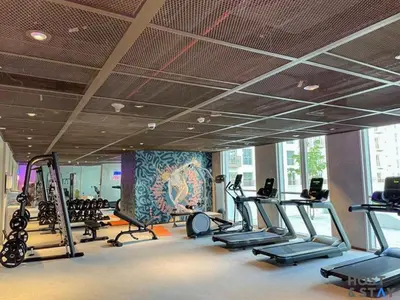 a gym with treadmills and elliptical machines at Amazing 1BR in Collective2, Dubai Hills in Dubai