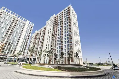 two tall buildings with palm trees in front of them at Modern 2BR Gem In Dubai Hills in Dubai