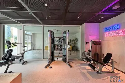 a gym with two treadmills and two tread machines at Serene 1BR Getaway In Collective in Dubai