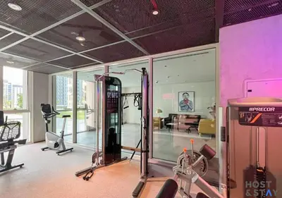 a room with a gym with tread machines in it at Serene 1BR Getaway In Collective in Dubai