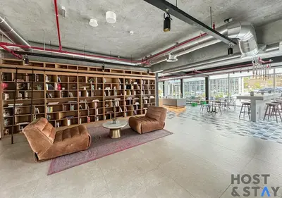 a room with a library with two chairs and a table at Stylish 1BR Apt In Collective 2 in Dubai