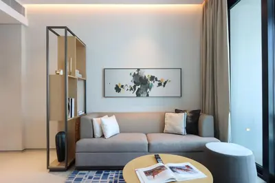 a living room with a couch and a table at 1BHK with Marina and Partial Sea Views in Dubai