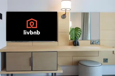 a living room with a tv on a desk at 1BHK with Marina and Partial Sea Views in Dubai