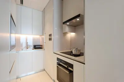a kitchen with white cabinets and a stove at 1BHK with Marina and Partial Sea Views in Dubai