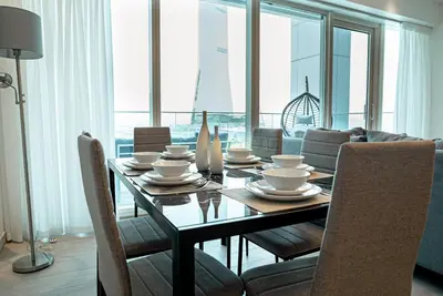 a dining room with a table and chairs with a view at Medore Brand New Flat in Dubai - 8 in Dubai