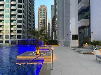 a pool in the middle of a city with buildings at Medore Brand New Flat in Dubai - 8 in Dubai