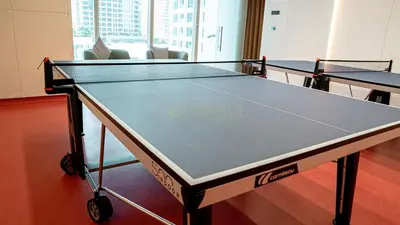 a ping pong table in a room with two tables at Medore Entire Brand New Flat in Dubai in Dubai
