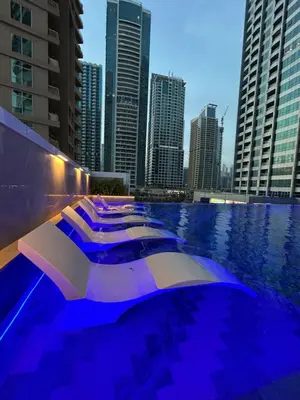a row of boats in a pool in a city at Medore Entire Brand New Flat in Dubai in Dubai
