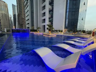 a swimming pool in a city with tall buildings at Medore Entire Brand New Flat in Dubai in Dubai
