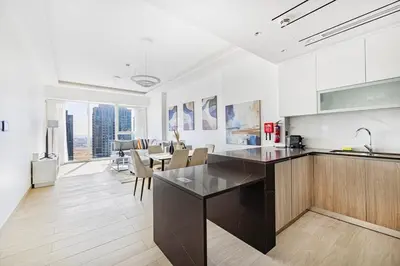 a kitchen with a counter and a dining room at Medore High Floor Brand New Apartment - 27 in Dubai