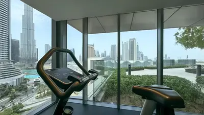a gym with a view of a city at Burj View Infinity Pool - Dubai Mall Connection in Dubai