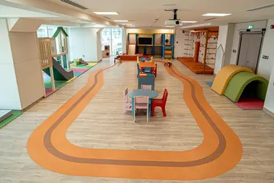 a school hallway with a stripe on the floor at High Floor Brand New Apartment - 34 in Dubai