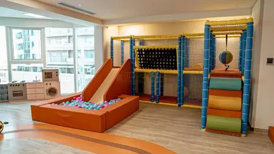 a childrens play room with a slide and a play equipment at High Floor Brand New Apartment - 34 in Dubai