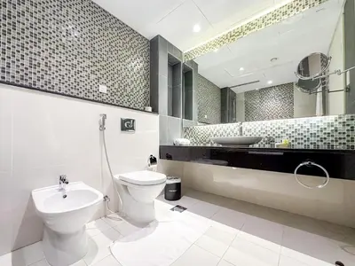 a bathroom with a toilet and a sink at Panoramic Burj Khalifa View Luxury 2BR Penthouse in Dubai