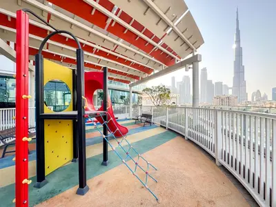 a playground on a building with a view of the city at Panoramic Burj Khalifa View Luxury 2BR Penthouse in Dubai