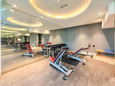 a gym with several treadmills and cardio machines at Panoramic Burj Khalifa View Luxury 2BR Penthouse in Dubai