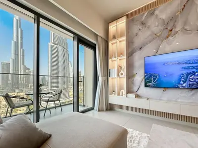 a living room with a large tv on a wall at Luxury - Fountain Show & Burj Khalifa View - 2 BR - 3 beds in Dubai