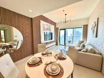 a living room with a table and a couch at Luxury - Fountain Show & Burj Khalifa View - 2 BR - 3 beds in Dubai