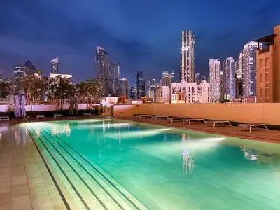 a swimming pool with a city skyline in the background at Luxury - Fountain Show & Burj Khalifa View - 2 BR - 3 beds in Dubai